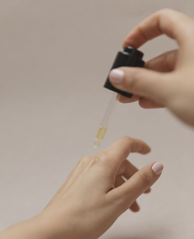 Applying ETEREA Retinol Alternative Face Oil with Bakuchiol, Rosehip, and Cacay Oils by Hueliá Botanicals to deeply moisturize, smooth skin, and enhance natural glow.
